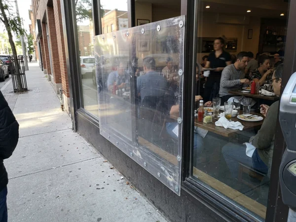 Clear polycarbonate temporary board-up over a restaurant window