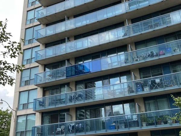 Condo facade where a replaced unit matches the surrounding glass