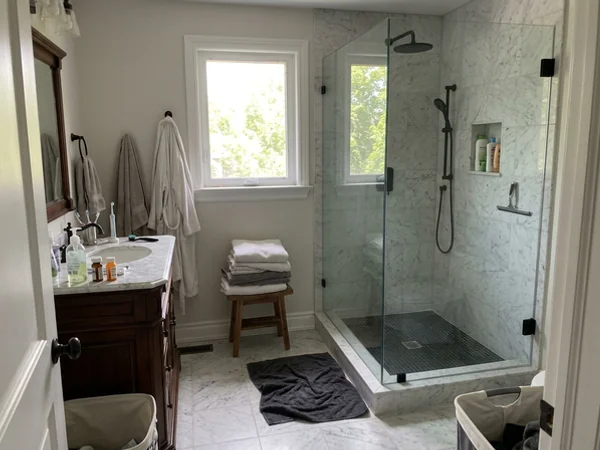 Walk-in Starphire shower with matte black clamps in Forest Hill