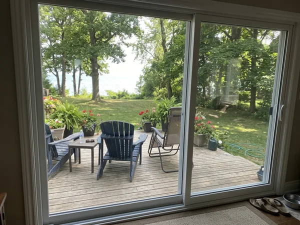 New clear Low-E patio door glass with a backyard view in Lorne Park