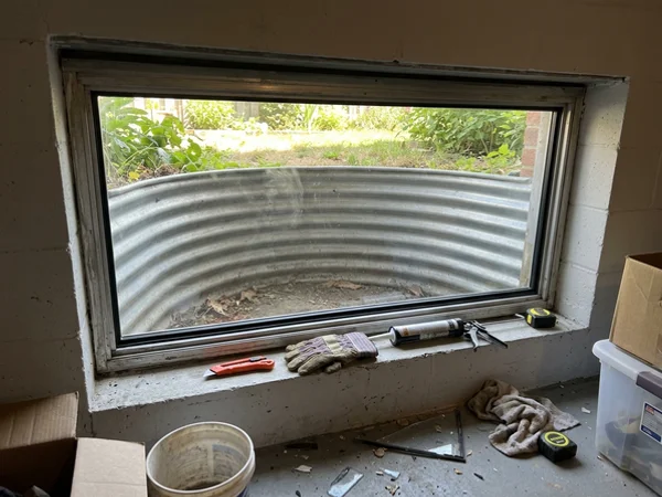 New pane in an aluminium basement window frame