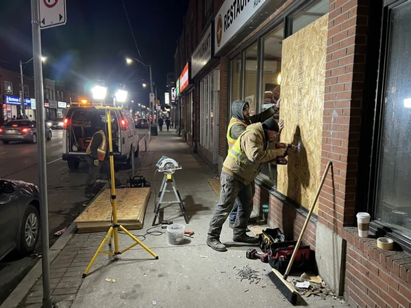 Night board-up of a restaurant window on the Danforth