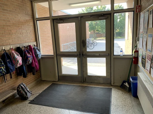 Repaired school entrance vestibule with laminated safety glass