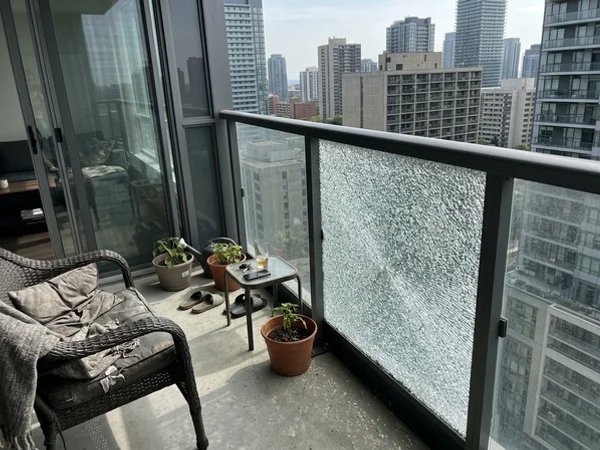 Spontaneously broken tempered balcony panel still in its frame